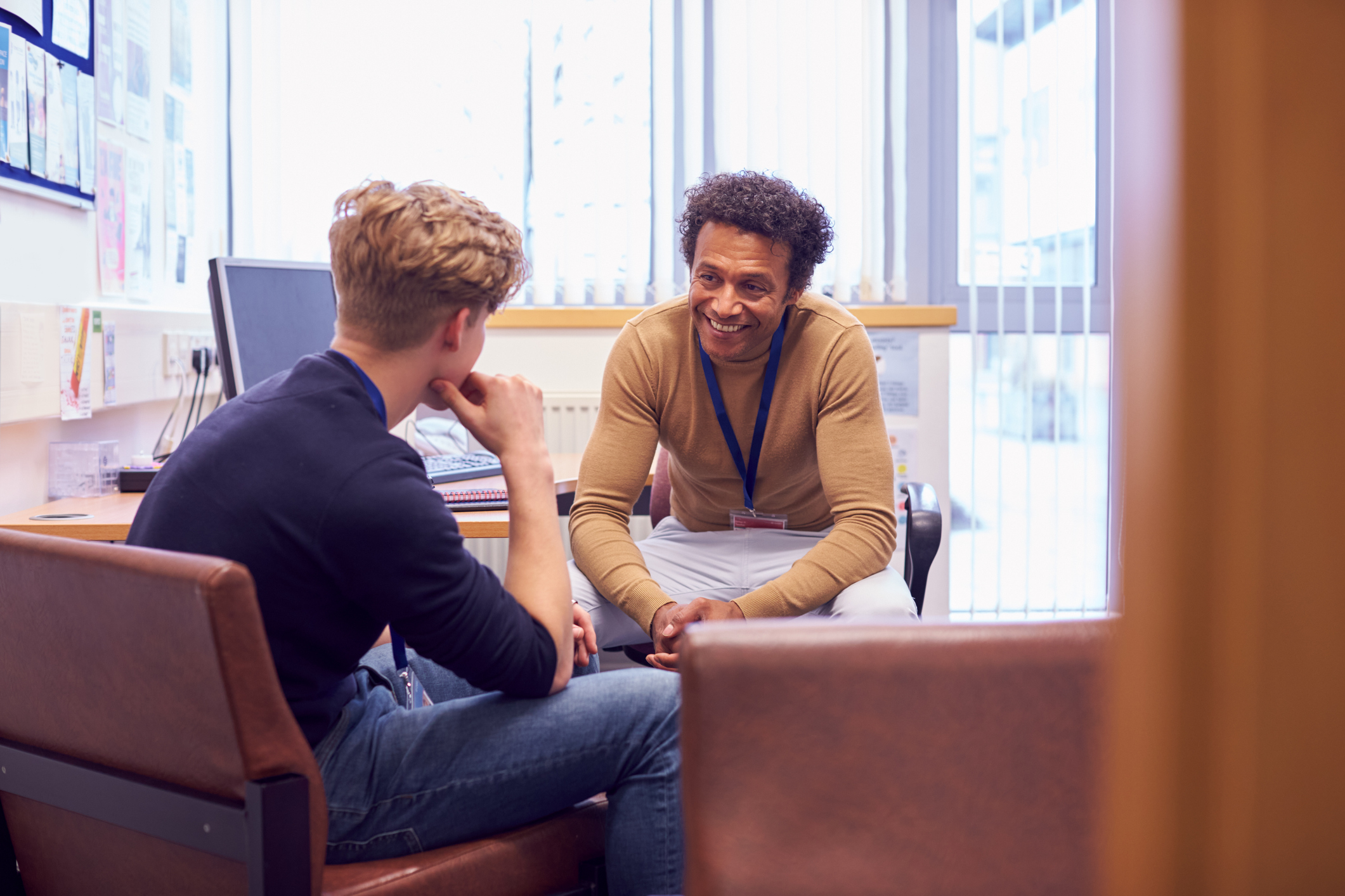 School counselor talking to student in office